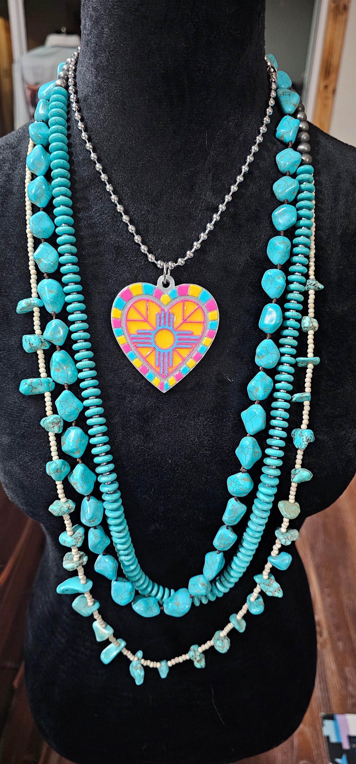 3d printed heart necklace shown with other turquoise strands