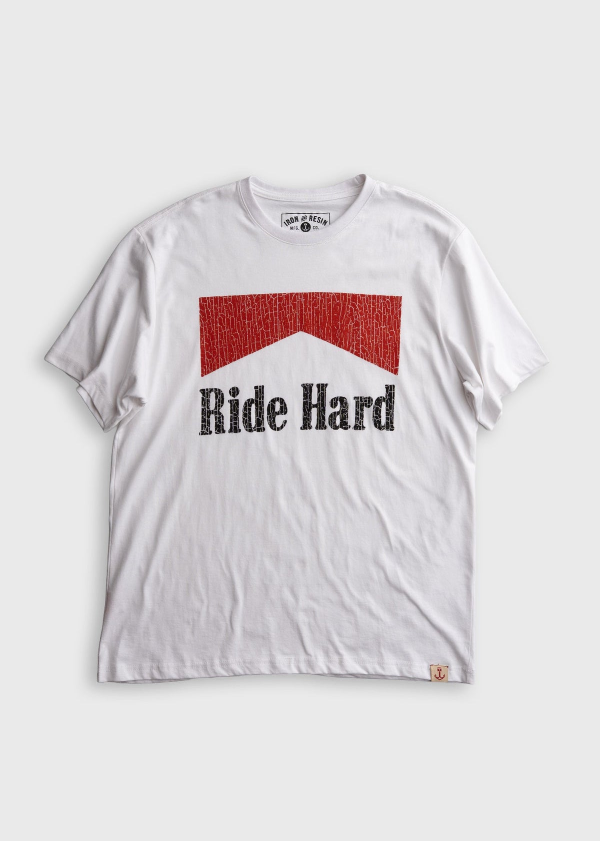 A white short-sleeve crewneck t-shirt with a red textured house-shaped graphic and the words 'Ride Hard' printed in black across the chest. The brand 'Sun & Moon' is visible on the inner neck label and a small tag near the bottom hem.
