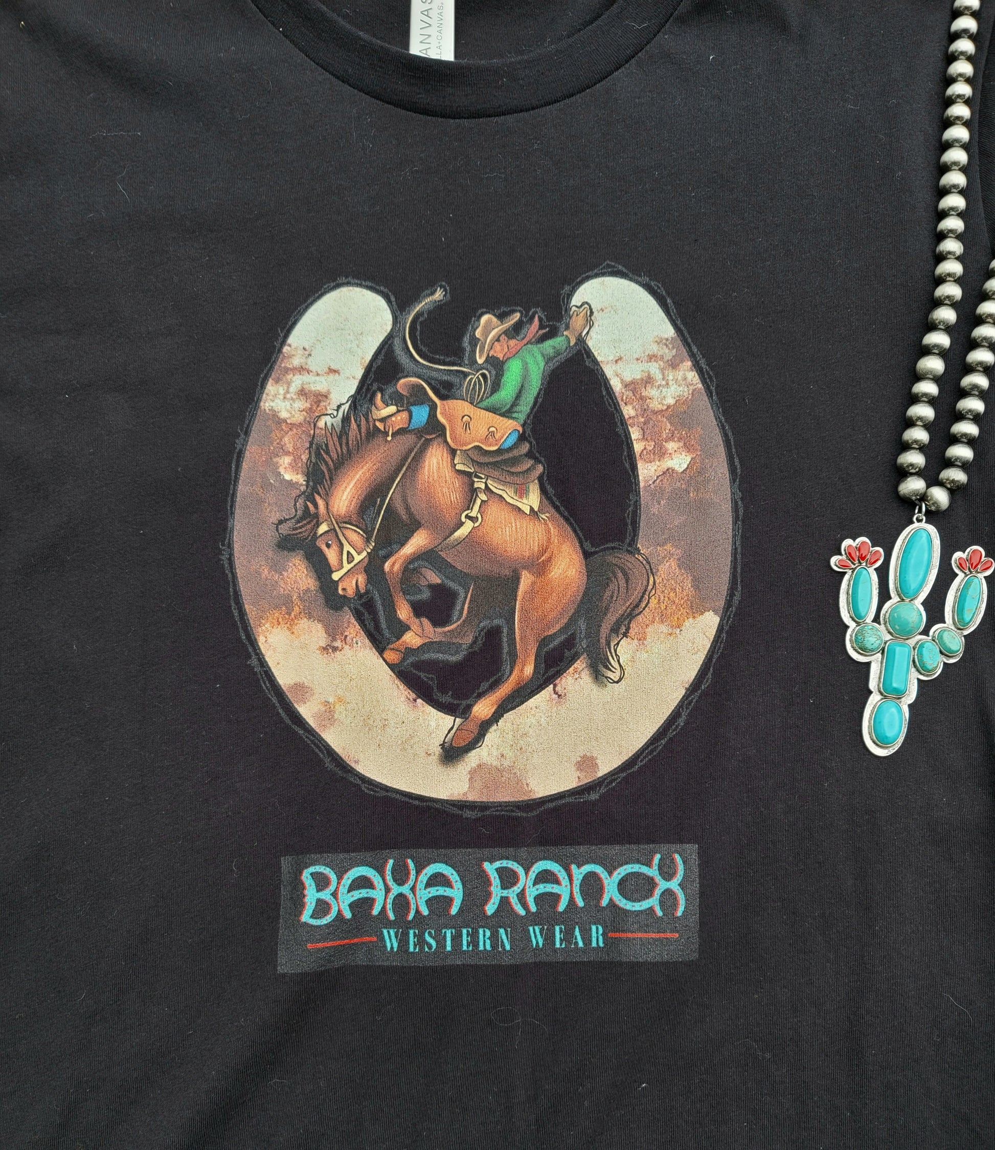 Baha Ranch Bronc Tee - baha ranch, baha ranch logo, black graphic tee, bronc, bronc rider, bronc riding, broncrider, broncriding, broncs, brown & white, brown and white, cow hide, cow print, cowboy, cowhide, cowprint, graphic, graphic t, graphic tee, graphic tees, horse shoe, horse shoes, horseshoe, tee, tshirt, unisex, unisex tee -  - Baha Ranch Western Wear