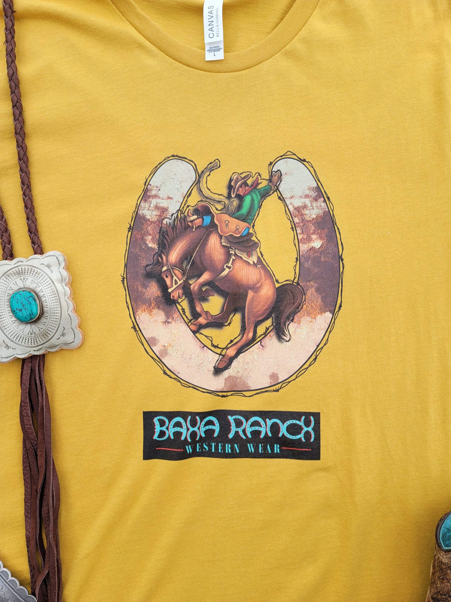 Baha Ranch Bronc Tee - baha ranch, baha ranch logo, bronc, bronc rideer, bronco, broncos, broncriding, brookshire, brown & white, brown color, cow print, cowboy, graphic t, graphic tee, horse shoe, horseshoe, horseshoes, mustard, mustard bull head, mustard color, mustard duster, mustard earring, mustard lace, mustard leather, mustard naja, mustard tank, mustard tee, tee, tshirt, unisex, unisex tee -  - Baha Ranch Western Wear