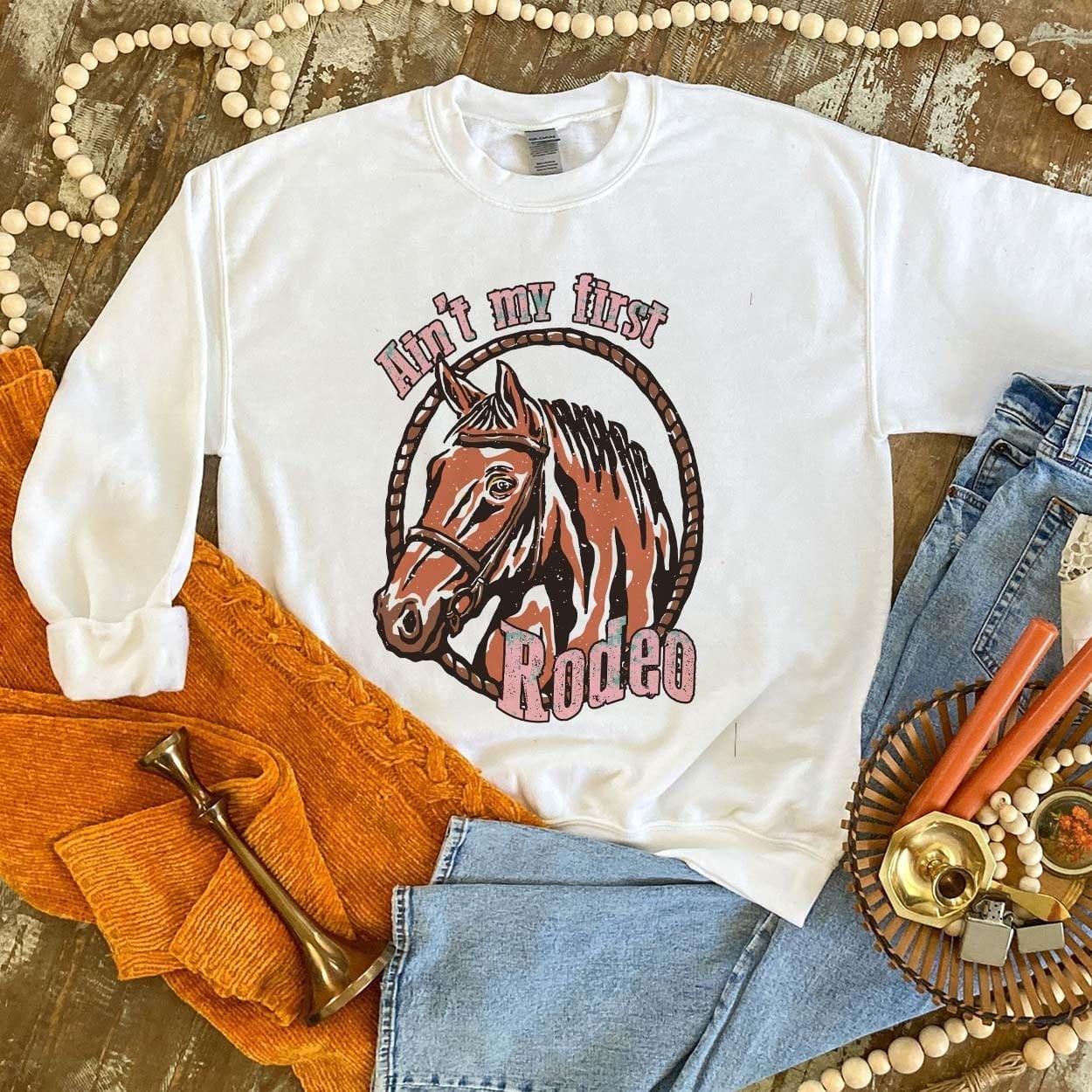 Ain't My First Rodeo Sweatshirt - boot, boots, cowboy hat, cowgirl, cowgirl hat, horseshoe, horseshoes, southwestern, sweat shirt, sweater, sweatshir, sweatshirt, western, white, white sweatshirt -  - Baha Ranch Western Wear