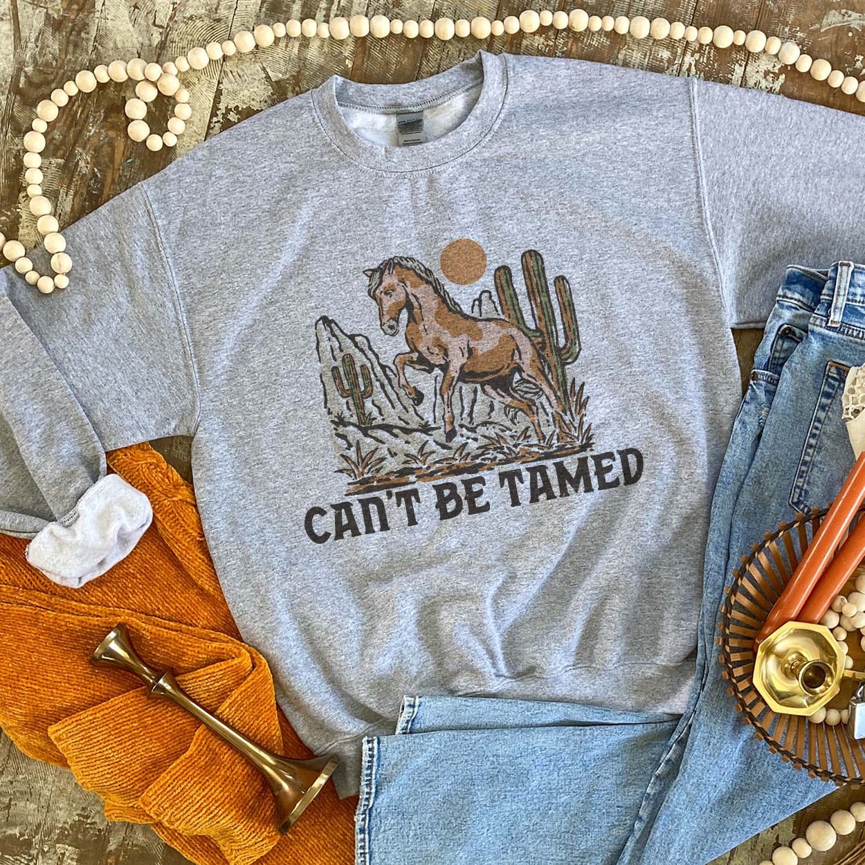 Can't Be Tamed Sweatshirt - boot, boots, cactus, cowboy hat, cowgirl, cowgirl hat, desert, free, horseshoe, horseshoes, southwestern, sweat shirt, sweater, sweatshir, sweatshirt, western, white, white sweatshirt, wild -  - Baha Ranch Western Wear